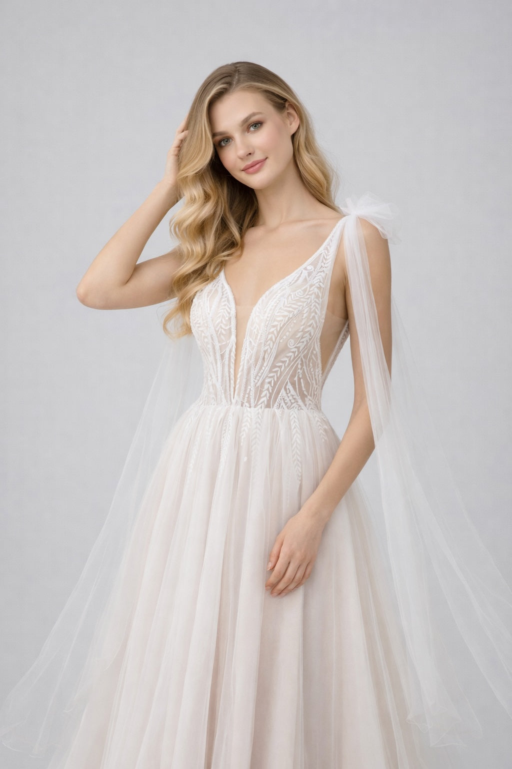 Robe de mariée Dressie Dress en tulle avec décolleté plongeant, broderies graphiques et longs pans drapés aux épaules.